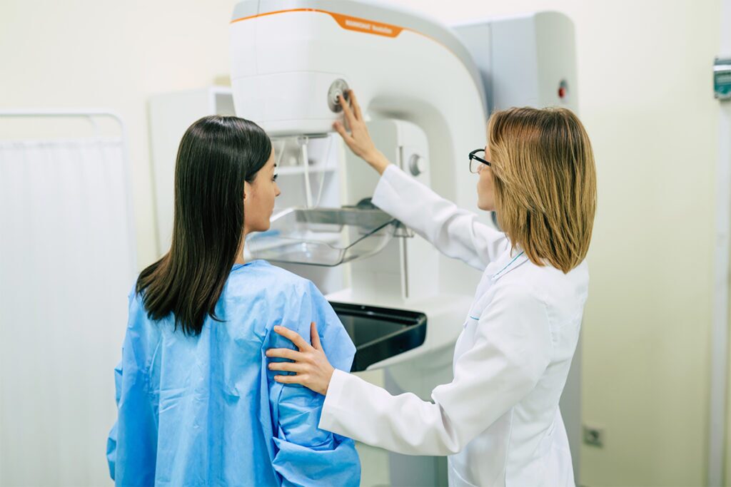 A young woman having a mammography examination with a female doctor